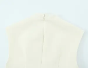 Back detail of cream mini dress featuring a high neck and hidden zipper closure.