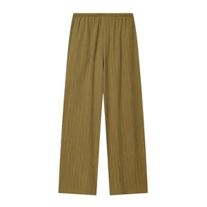 Detail of olive green high-waist wide-leg pants with textured fabric and elastic waist