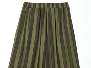 Detailed view of olive green and black vertical striped wide-leg pants with elastic waistband