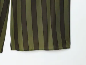 Macro view of the green and dark striped hem detail for women's fashion wide-leg pants