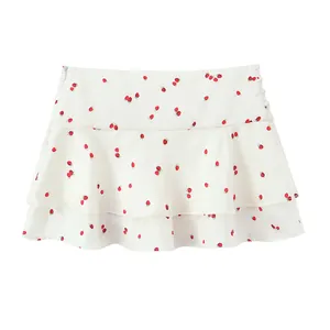 Detail shot of the white strawberry print layered mini skirt with a smooth satin texture