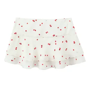 White tiered mini skirt featuring an all-over red strawberry print on satin-like fabric.