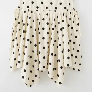 Fashionable white mini skirt with black polka dots and an elegant asymmetrical hemline