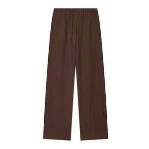 Close-up view of dark brown textured wide-leg trousers featuring an elastic waistband
