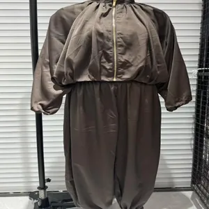 Detailed view of women's dark bronze satin puff sleeve bomber jacket and harem pants set