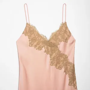Elegant pink satin slip dress featuring golden lace trim and a flattering V-neckline