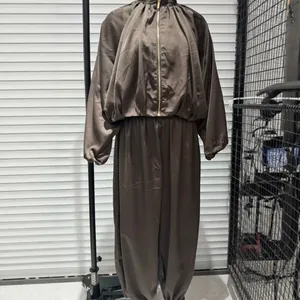 Elegant brown satin two-piece outfit featuring bubble sleeve bomber jacket and lantern pants