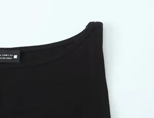 Detail of black minimalist sleeveless T-shirt showing neckline and fabric texture