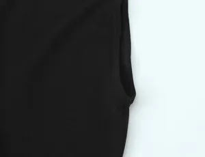 Close-up macro view of the double-stitched armhole detail on a black minimalist sleeveless T-shirt