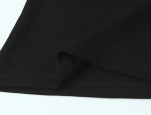 Macro view of fine ribbed fabric and double-stitched hem on black sleeveless T-shirt