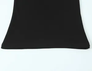 Close-up of the double-stitched hem on a black minimalist sleeveless T-shirt.