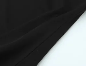 Detailed close-up showing the smooth texture and weave of the black cotton fabric