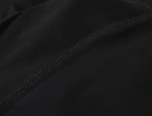 Close-up detail of high-quality stitching on a minimalist black sleeveless T-shirt.