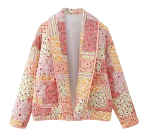 Detailed close-up view of this pink floral patchwork quilted jacket with pockets