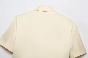 Detailed back view of light cream short-sleeved blazer jacket with notch lapel collar
