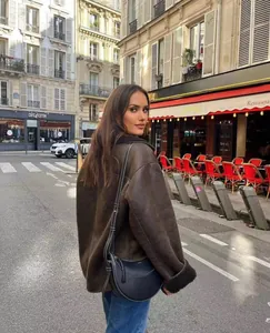Stylish brown faux shearling lapel jacket for women shown in an outdoor street setting