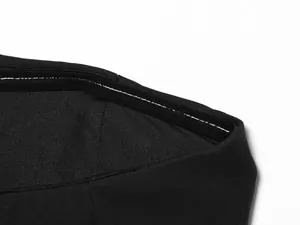 Macro detail showing high-quality white contrast stitching on a black fabric hemline