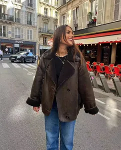 Model wearing a stylish brown faux shearling lapel jacket on a Parisian street scene