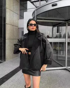 Stylish women's black faux leather jacket with lamb wool collar and cuffs.