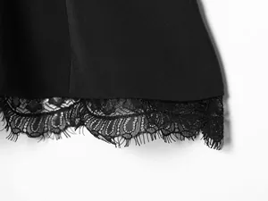 Close-up macro detail of black tube top featuring delicate eyelash lace hem trim detail