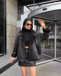 Stylish women's black lamb wool lapel jacket worn by model in urban street setting