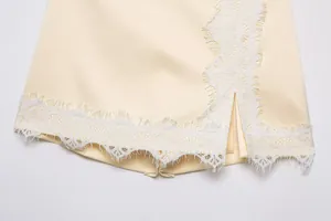 Close-up detail of cream lace patchwork skort showing delicate eyelash lace trim