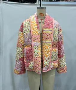 Detailed view of women's floral patchwork quilted jacket with lapel collar on mannequin