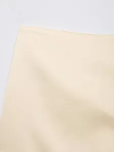 Close-up of smooth cream fabric texture of the stylish lace patchwork skirt-pants