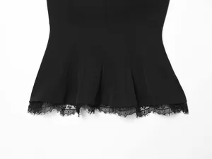 Close-up of elegant eyelash lace hem on a black strapless corset top for women
