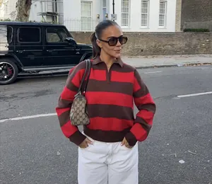 Stylish woman in a red and brown striped polo knit sweater for street fashion looks