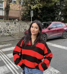Red and black striped oversized knit sweater for women, stylish street style outfit.