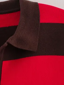 Close-up detail of the knit texture and polo collar on a red and brown striped sweater.