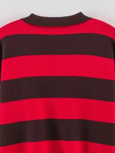 Detail shot of contrast red and black striped knitted sweater with ribbed texture