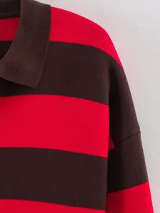 Close-up detail showing the soft texture of a red and brown striped knitted polo sweater
