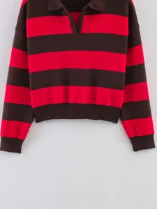 Detail of red and brown striped knit sweater with polo collar and ribbed cuffs.