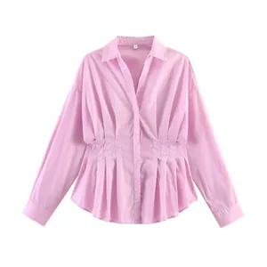 Vista dettagliata della camicia rosa a maniche lunghe con elegante vita a pieghe.