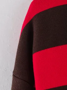 Macro detail of red and brown striped knit sweater fabric showing texture