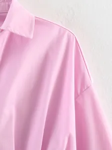Dettaglio di una camicia rosa con colletto a polo che mostra la trama del tessuto