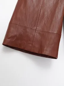 Gros plan détaillé montrant la texture et les coutures du vêtement en cuir marron