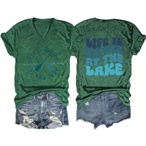 Detail view showing the front and back graphic prints of the "Life is better at the lake" tee.
