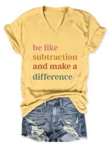 Close-up of yellow V-neck t-shirt with 'be like subtraction' slogan and denim shorts