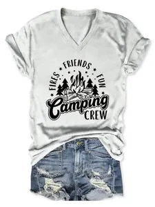 Detailed view of the Camping Crew campfire graphic on a white ladies V-neck summer T-shirt