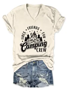Detailed view of women's cream V-neck T-shirt with Camping Crew graphic and denim shorts