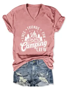 Detail view of pink V-neck T-shirt with Camping Crew graphic and denim shorts