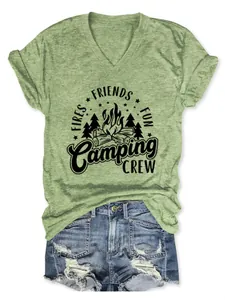 Close-up detail of light green V-neck T-shirt with black Camping Crew graphic print