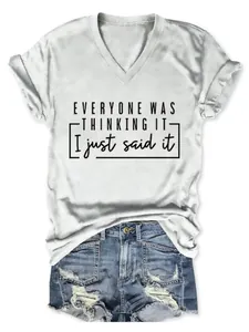 Détail d'un t-shirt blanc à col en V avec le slogan 'Everyone was thinking it'.