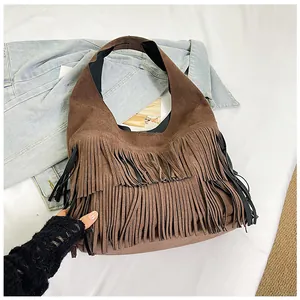 Close-up detail of a vintage brown suede hobo bag featuring stylish long fringe tassels