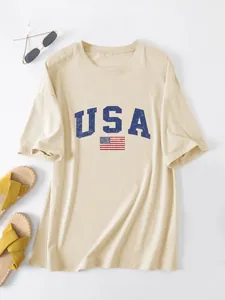 Casual women's oversized beige T-shirt featuring USA flag print and blue lettering