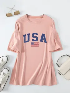 Close-up of the navy USA letter and flag print on a pink oversized women's T-shirt