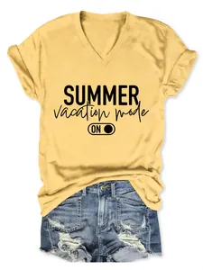 Detail of a yellow V-neck tee with Summer Vacation Mode print and denim shorts.